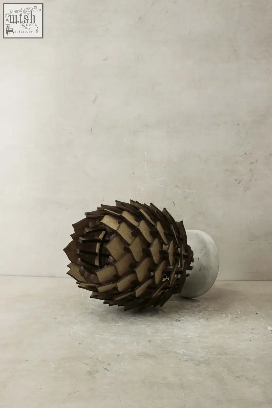 Protea table lamp s with a dark brown pinecone design made of layered wood segments and a concrete base table lamp