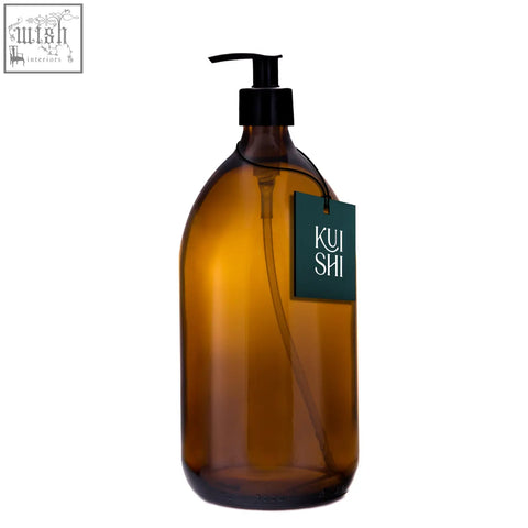 Amber glass pump bottle dispenser with black pump and dark green kui shi logo tag for easy dispensing