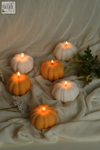 Six smooth wax pumpkin shaped candles in orange and white perfect for pumpkin spice decor and cozy vibes