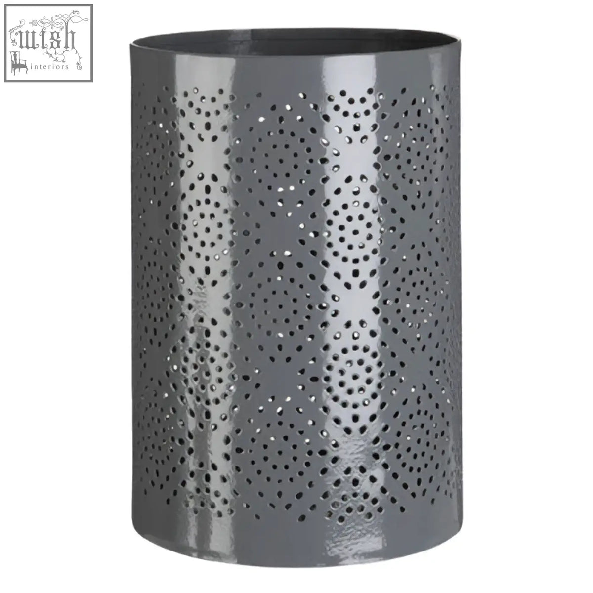 Grey candle holder with punched metal pattern featuring circular perforations for large candle use