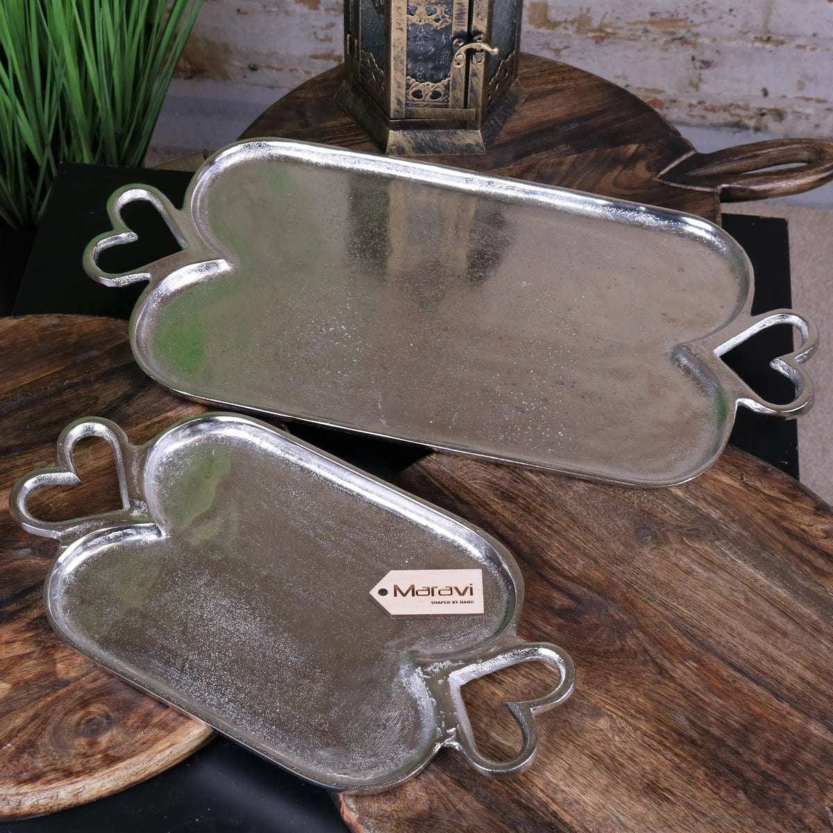 Silver heart-shaped serving trays with matte textured finish and ornate handles from punji luxury serving trays set