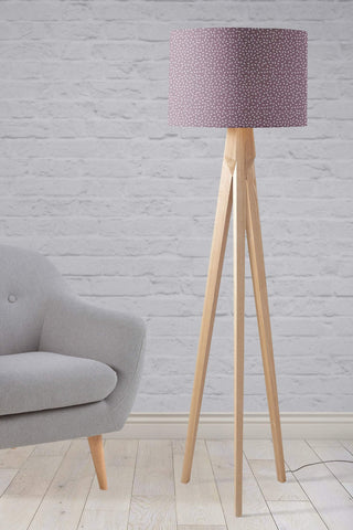 Modern line table lamp with a purple lampshade featuring a subtle speckled pattern and wooden tripod legs
