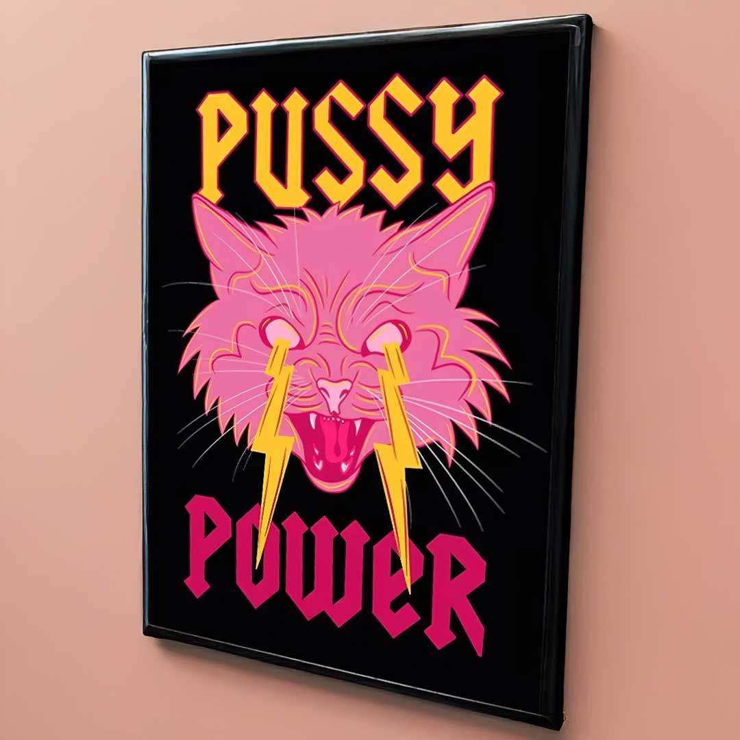 A framed pussy power print featuring a vibrant pink cat with lightning bolt tears and bold yellow magenta text on black background