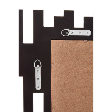 Black metal puzzle wall mirror with cut out frame featuring corkboard backing and silver toned hardware central reflective pane