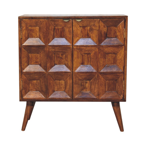 A mid-century modern quad cabinet made of warm brown mango wood with geometric 3d panel doors