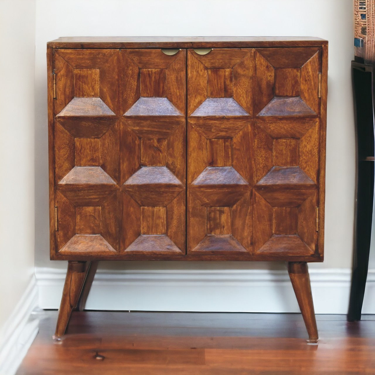 A mid-century modern quad cabinet in warm brown mango wood with geometric raised diamond paneling