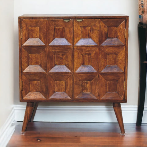 A mid-century modern quad cabinet in warm brown mango wood with geometric raised diamond paneling