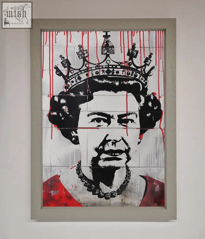 A framed black and white queen elizabeth graffiti poster with red blood drips wearing crown and pearl necklace