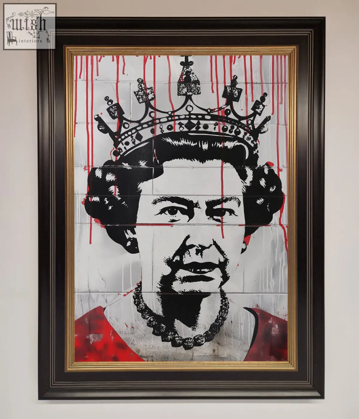 Framed queen elizabeth graffiti poster with black and red stencil art on tiled wall in dark wood frame with gold border
