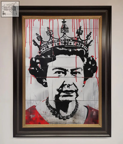 Framed queen elizabeth graffiti poster with black and red stencil art on tiled wall in dark wood frame with gold border