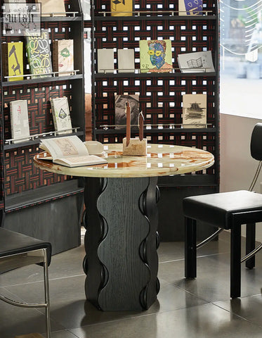 Quintero dining table round with a polished beige and brown round marble top and dark gray sculpted base perfect as dining table