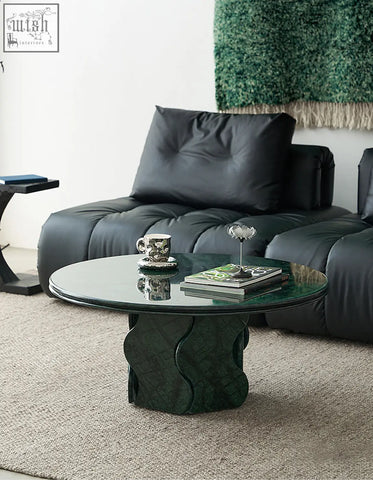 Quintero round coffee table with emerald green glass top and sculpted textured solid wood base ideal as a marble coffee table alternative