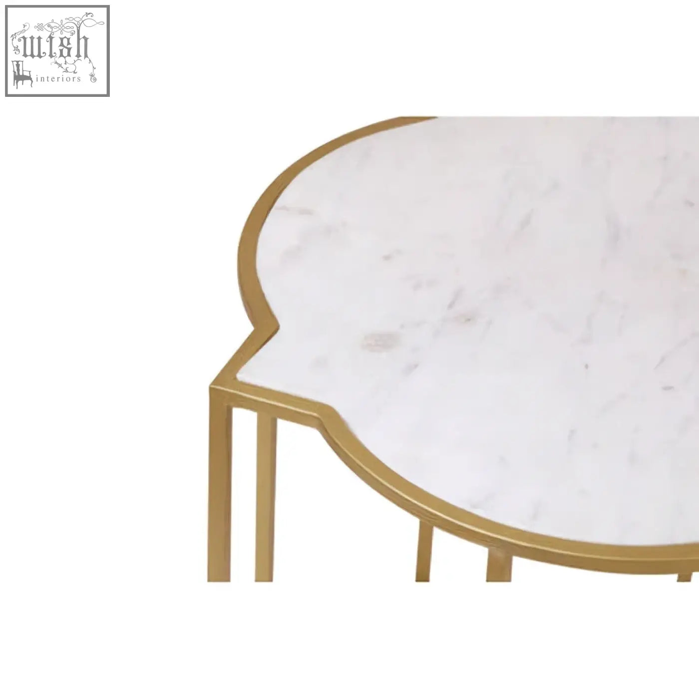 White marble coffee table with gold-toned metal legs and curved cloud-like edge from rabia set with marble tops and upscale styling