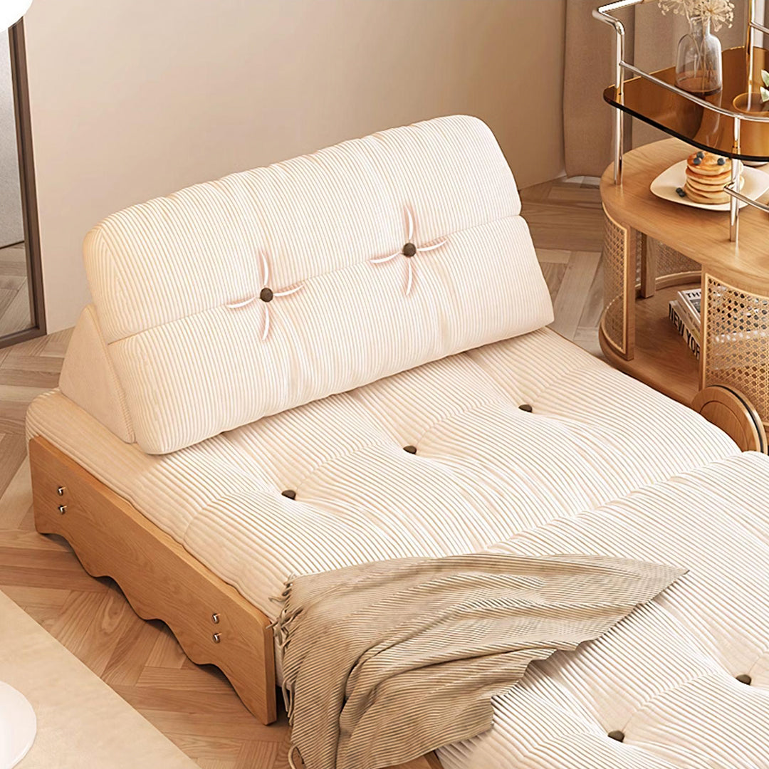 Cream-colored corduroy rachman sleeper armchair with tufted backrest and wooden base as a single seater bed