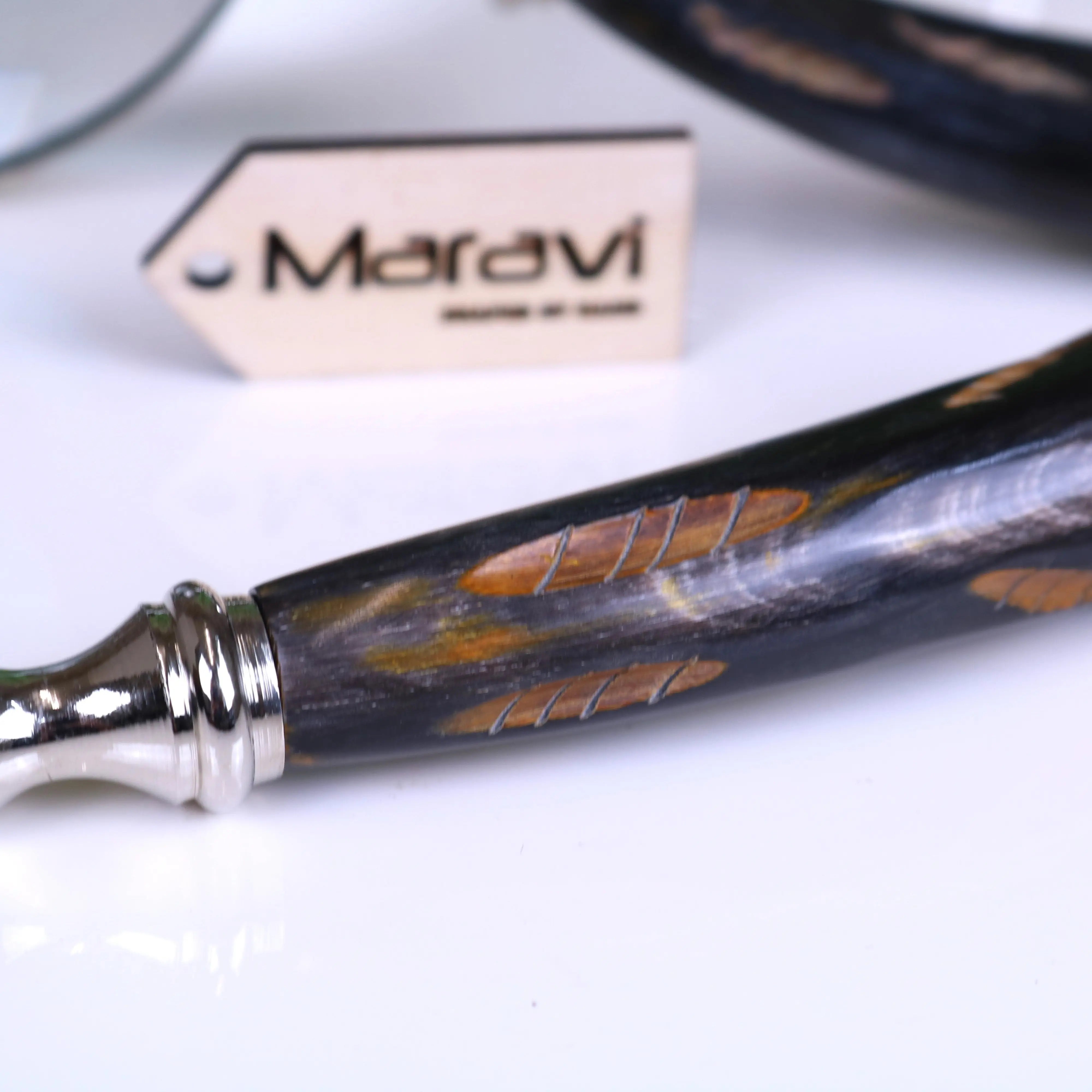 Black and gold inlaid handle with polished silver ferrule on rada magnifying glass featuring elegant maravi label