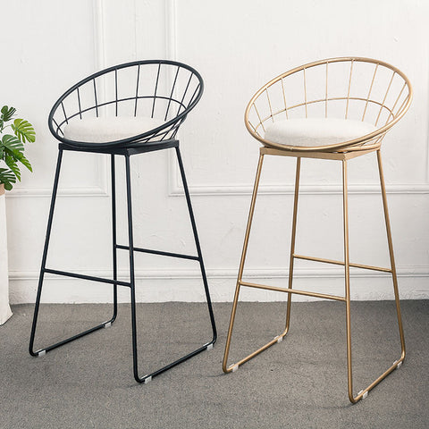 Two modern rafael sphere bar stools with wireframe metal frames in black and gold and white cushioned seats