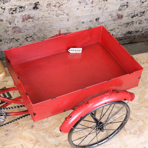 Red metal rahi vintage style tricycle ornament with rectangular cargo bed and black spoked wheels in vintage style