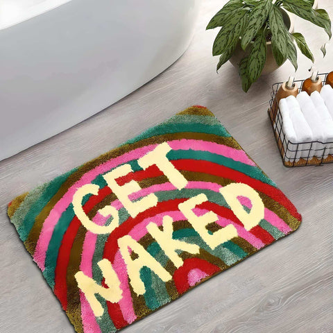 A colorful plush naked bathmat with a vibrant rainbow design and bold cream letters saying get naked