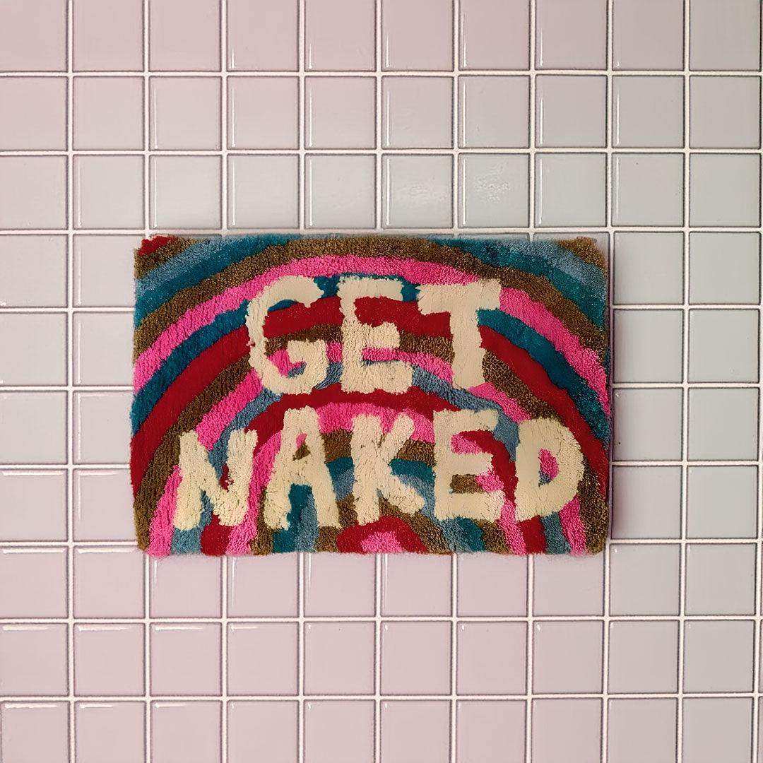 Colorful textured naked bathmat with get naked cream letters on vibrant rainbow pink red blue and brown pattern