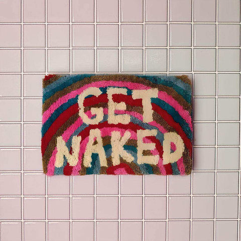 Colorful textured naked bathmat with get naked cream letters on vibrant rainbow pink red blue and brown pattern
