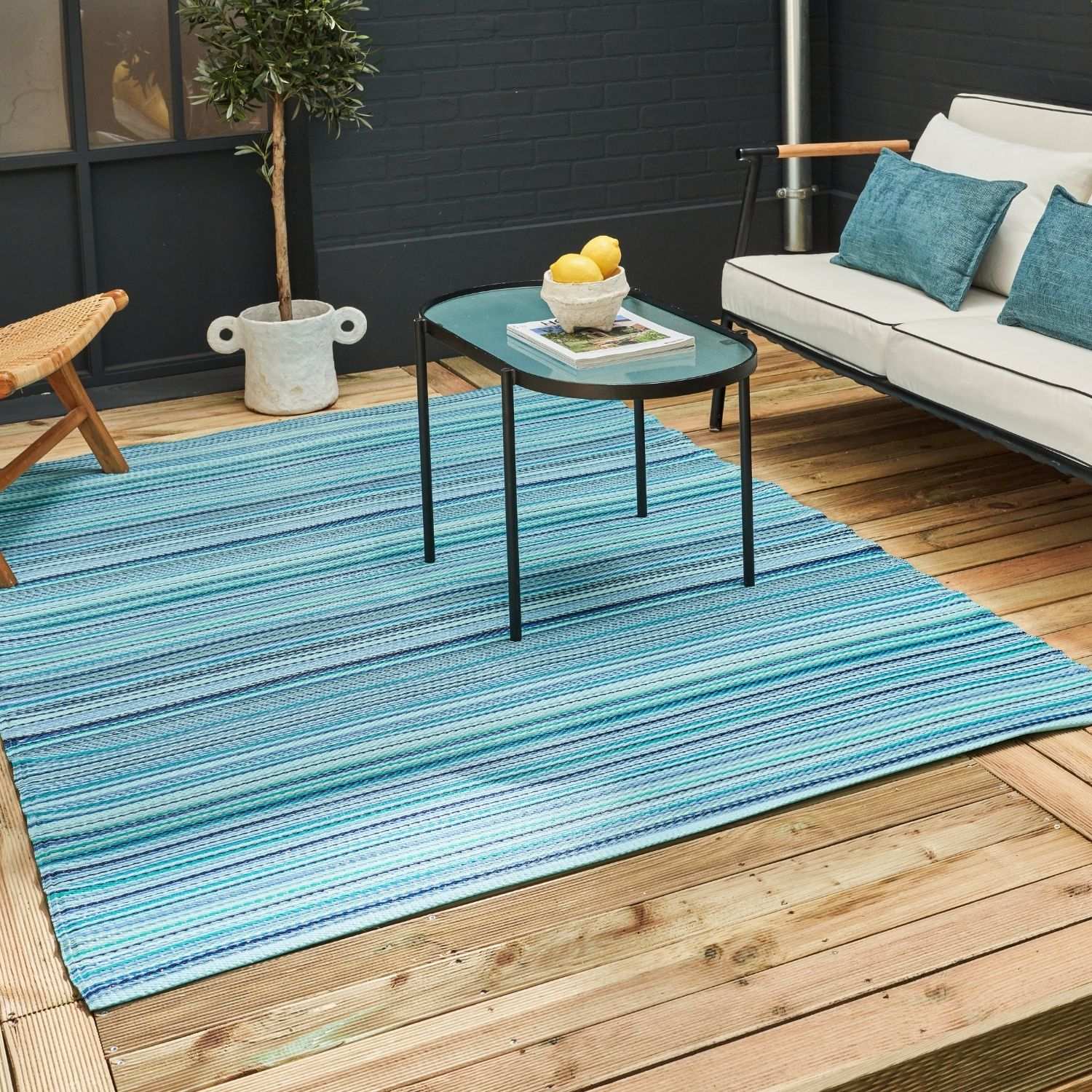 Blue striped outdoor rug featuring rainbow outdoor rug design in blue perfect for outdoor use