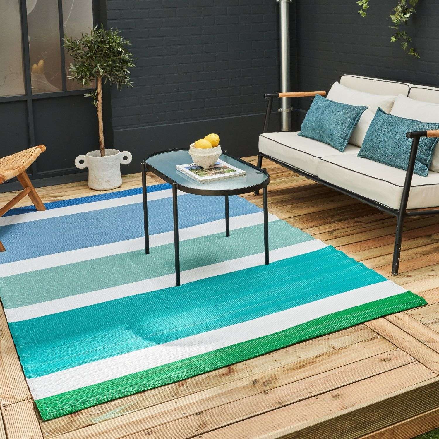 Vibrant rainbow outdoor rug blue with bold teal turquoise and green stripes separated by crisp white for outdoor use