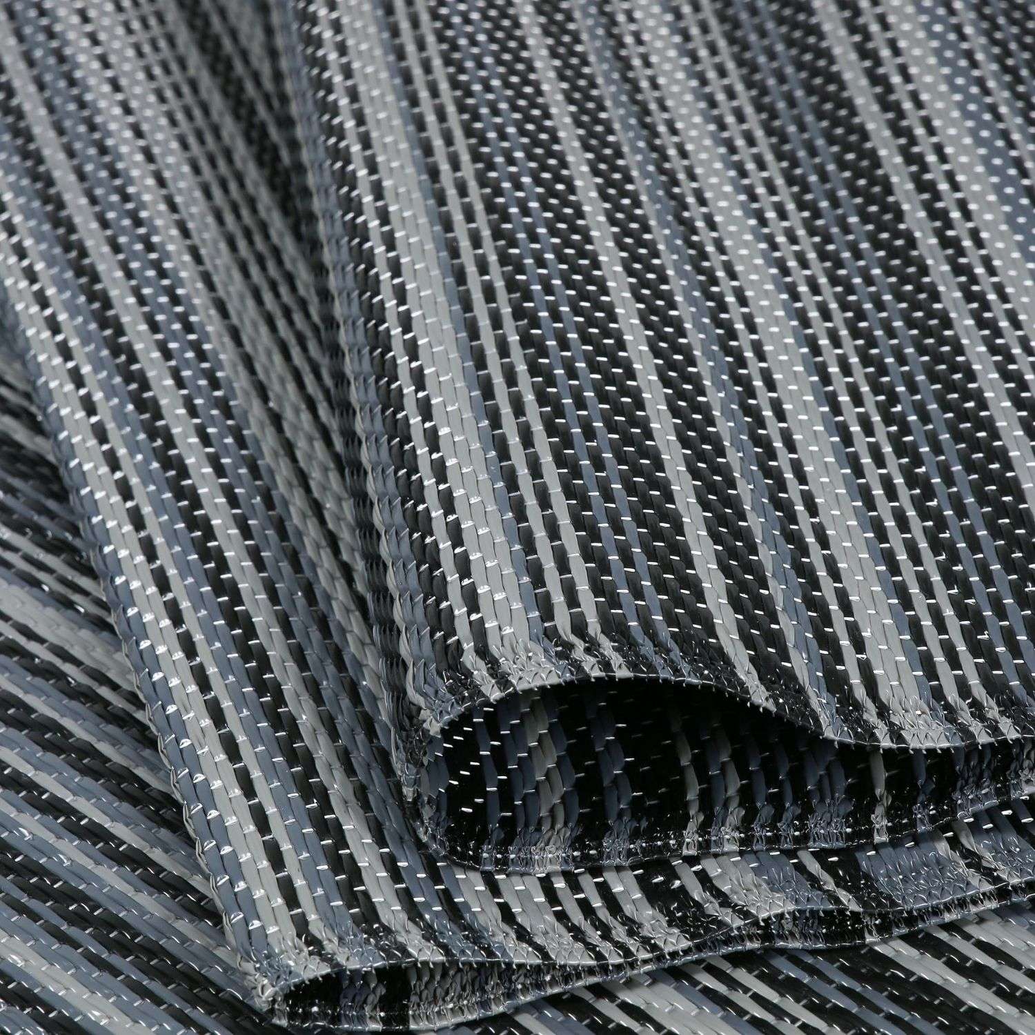 Dark grey rainbow outdoor rug with black and silver woven textured interlaced fabric for outdoor use