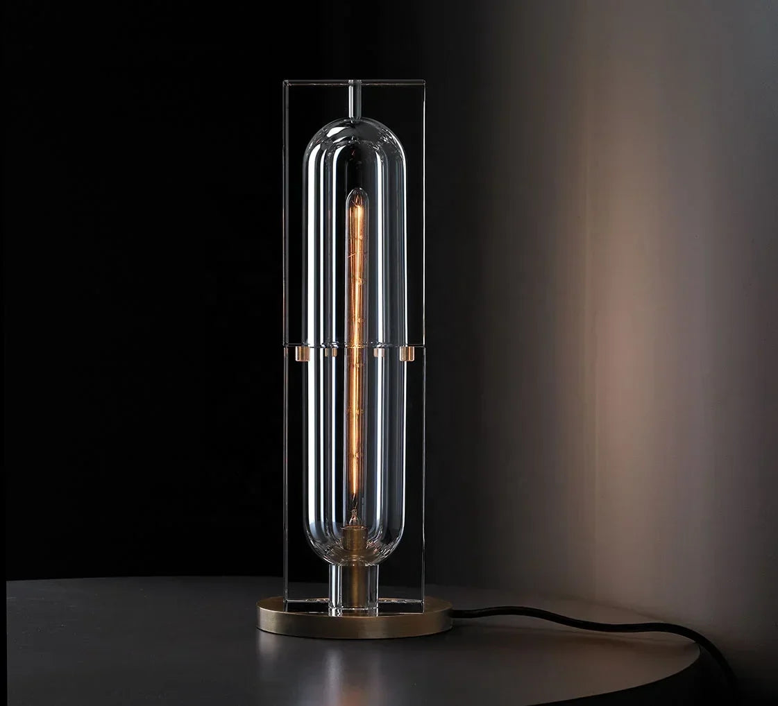 Raito Light sleek modern table lamp with clear glass and illuminated edison-style filament bulb in brushed brass finish