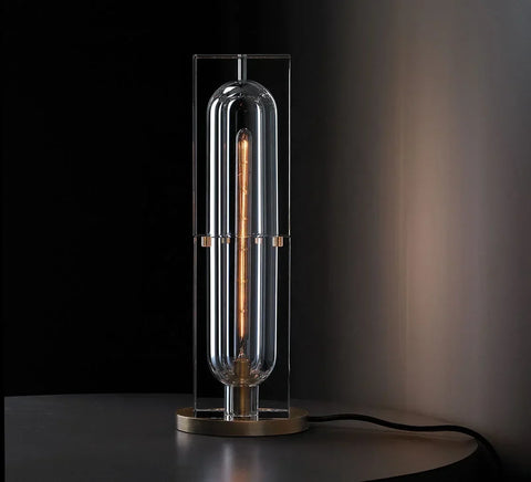 Raito Light sleek modern table lamp with clear glass and illuminated edison-style filament bulb in brushed brass finish