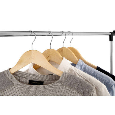 A ralesi chrome frame clothes rack holding light wood hangers with soft neutral tone sweaters displayed neatly