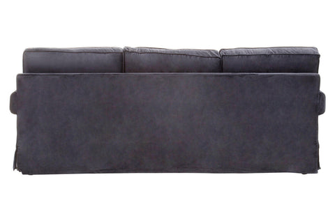 Dark gray suede sofa with three seat cushions and low backrest resembling a black velvet sofa style