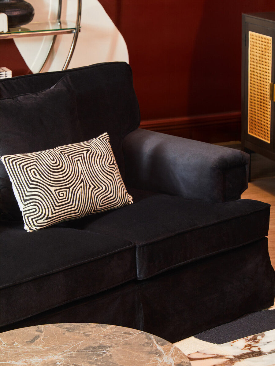 Ralph three seat black velvet sofa with a geometric patterned throw pillow for stylish living room seating
