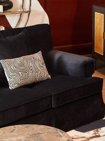 Ralph three seat black velvet sofa with a geometric patterned throw pillow for stylish living room seating