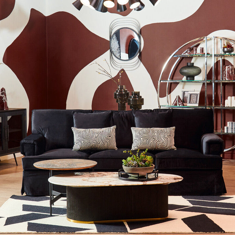 Ralph three seat black velvet sofa with two patterned throw pillows featuring soft black velvet upholstery