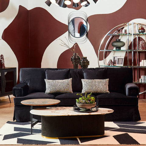 Ralph three seat black velvet sofa with two patterned throw pillows featuring soft black velvet upholstery