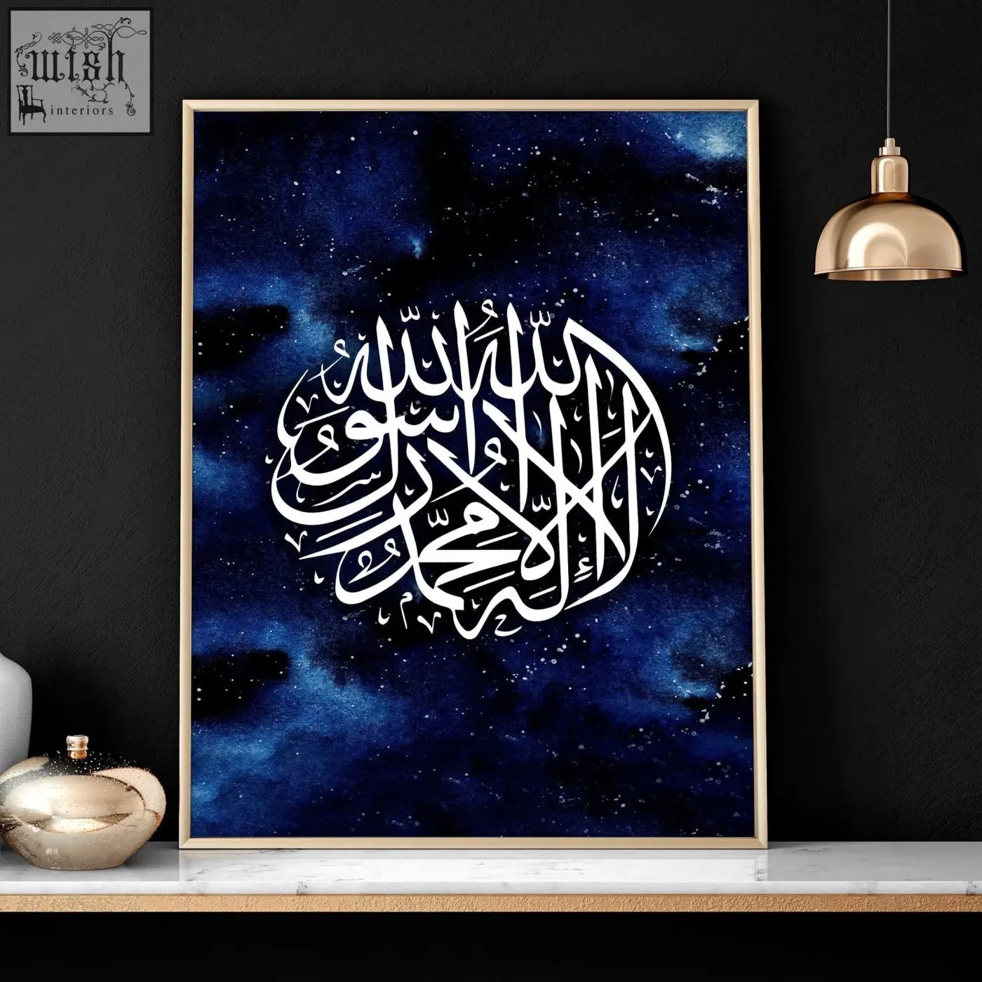 A framed ramadan wall art print with white islamic calligraphy on deep blue cosmic background in gold frame