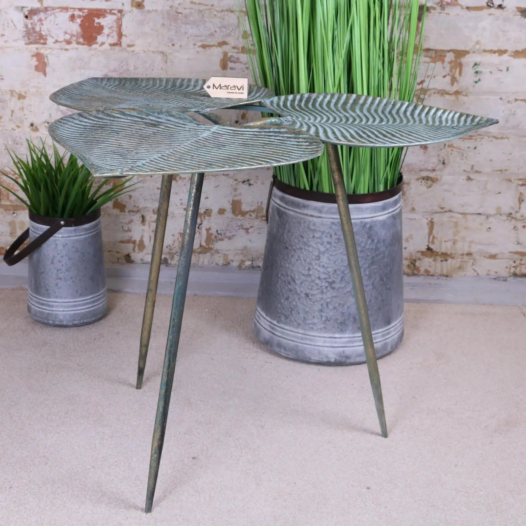 Metallic green three leaf side table with three slender legs in the ramai three leaf collection