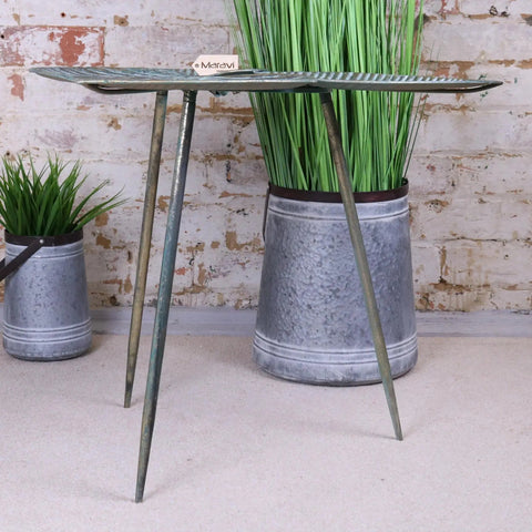 Rustic green painted metal ramai three leaf side table with leaf patterned top and three slender legs