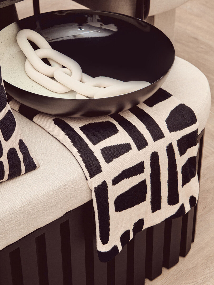 Black ceramic ombre bowl with glossy finish holding chunky white chain perfect as a white ombre bowl decor piece