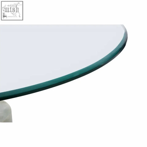 Clear glass tabletop with smooth rounded edge and greenish tint on rany glass and white marble side table with marble base
