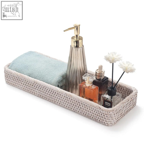 Beige woven rattan bathroom vanity tray with light blue towel and soap dispenser perfect for toilet tank storage