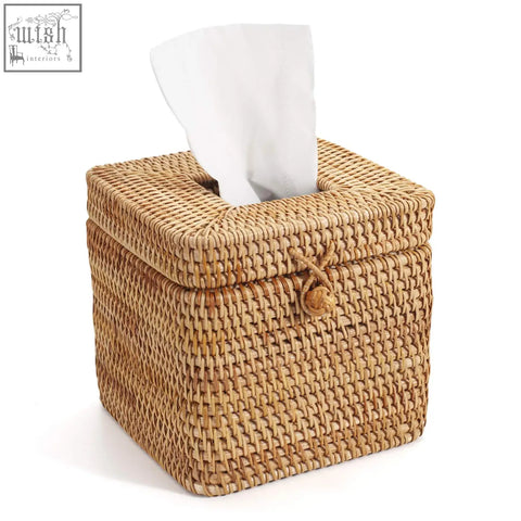 Natural woven rattan square tissue box with tied rope closure and white paper towel partially pulled out