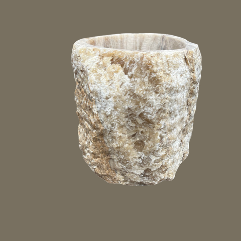A rustic onyx planter pot with a raw edge and mottled creamy white and brown agate stone 60cm diameter