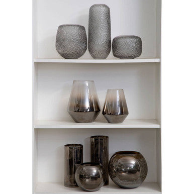 A collection of small rounded glass vases with sleek metallic gradient finish and subtle textured patterns