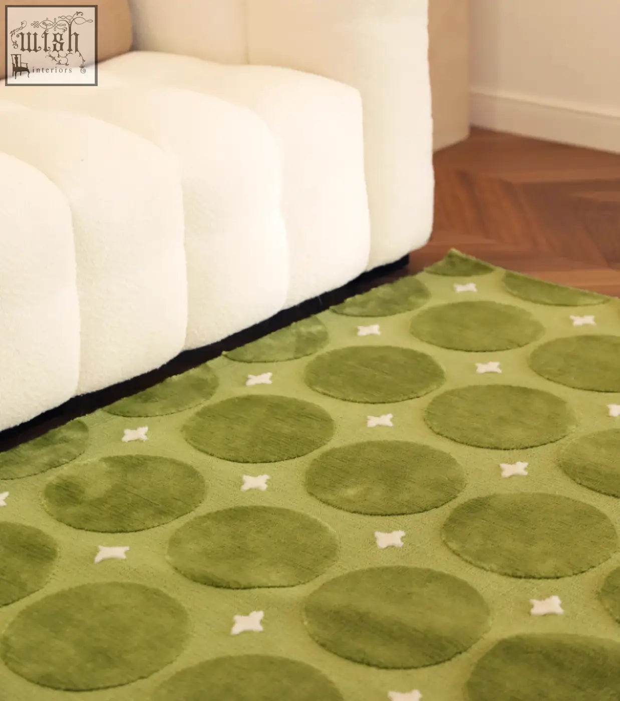 Rebekah living room rug green with circular patterns and white cross accents perfect for coffee table set area
