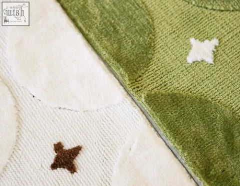 Rebekah living room rug with green and white textured fabric and embroidered stars perfect for coffee table sets