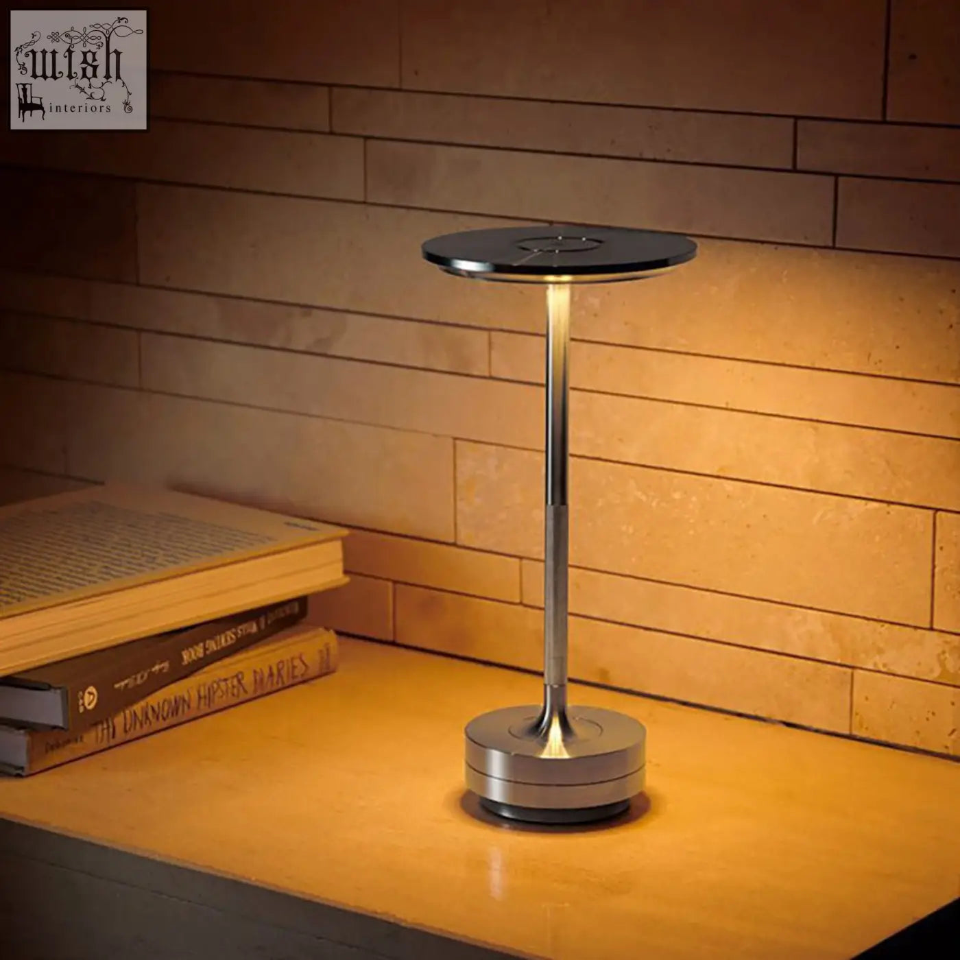 Modern minimalist rechargeable table lamp with chrome aluminium stem and black top emitting warm light