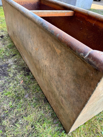 Rusty brown reclaimed galvanised metal trough planter with a weathered industrial look for raised beds and herbs