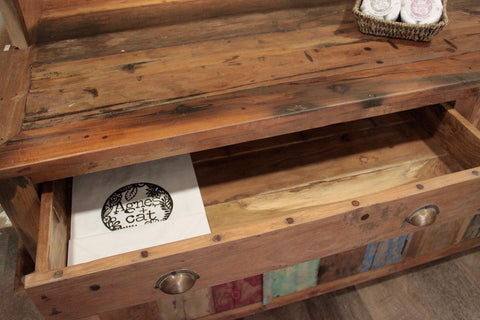 Rustic recycled teak wood centre display table with weathered finish and colorful patchwork panels on front