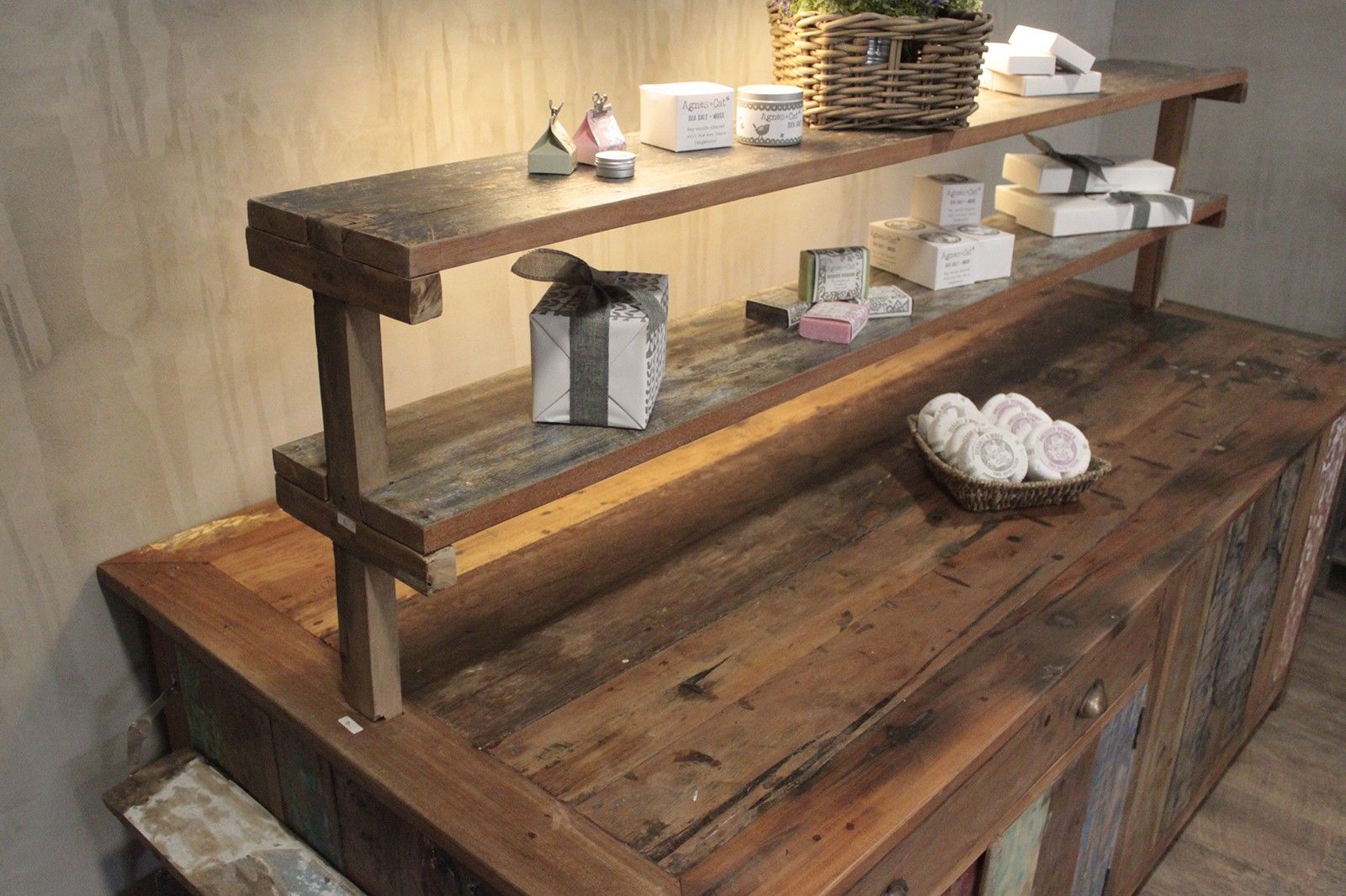 Rustic recycled teak wood centre display table with weathered reclaimed wood and sturdy exposed frame construction